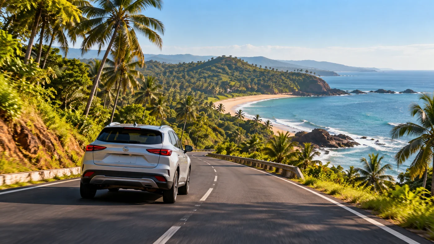 Illustrative coastal road with a passenger SUV, green headlands and views across the Arabian Sea